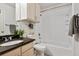 Clean bathroom with granite countertop, tub-shower combo, and white tile at 4804 E Kentucky Ave # D, Denver, CO 80246