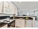 Updated kitchen featuring white cabinetry, modern appliances and a breakfast bar at 4804 E Kentucky Ave # D, Denver, CO 80246