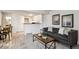 The living room features wood floors, stylish furniture, and a view into the kitchen at 4804 E Kentucky Ave # D, Denver, CO 80246