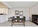 Inviting living room with a cozy fireplace, modern decor, and a view to the kitchen at 4804 E Kentucky Ave # D, Denver, CO 80246