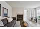 Comfortable living room with gray sofa, fireplace, and wood-look floors at 4804 E Kentucky Ave # D, Denver, CO 80246