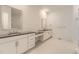 Modern bathroom with double sinks, vanity, and tiled floors at 3953 Treadway Pt, Castle Rock, CO 80108
