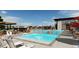 Resort-style community pool with ample seating, sun umbrellas, and a modern pool house for residents' enjoyment at 3953 Treadway Pt, Castle Rock, CO 80108