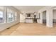 Open-concept living room leading to a modern kitchen with a large island and lots of natural light at 3953 Treadway Pt, Castle Rock, CO 80108