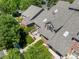 Aerial view of townhouse complex featuring well-maintained landscaping, patios, and shingle roofs at 8105 E Bayaud Ave, Denver, CO 80230