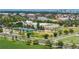 Wide aerial view of a community featuring tennis courts, park, and schools with the city skyline in the distance at 8105 E Bayaud Ave, Denver, CO 80230