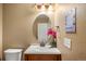 Charming bathroom featuring a classic vanity, oval mirror, and stylish lighting, creating a warm and inviting space at 8105 E Bayaud Ave, Denver, CO 80230