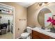 Compact bathroom with vanity, toilet, and convenient laundry area at 8105 E Bayaud Ave, Denver, CO 80230