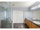 Bathroom with a walk-in shower, tiled floor, dual sinks, and a large cabinet at 8105 E Bayaud Ave, Denver, CO 80230