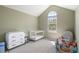 Bright bedroom with a vaulted ceiling, large arched window, and white furniture, perfect for a Bedroom at 8105 E Bayaud Ave, Denver, CO 80230