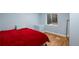 Cozy bedroom featuring a bright window and contemporary flooring at 8105 E Bayaud Ave, Denver, CO 80230