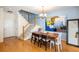 Cozy dining area with modern art and staircase access at 8105 E Bayaud Ave, Denver, CO 80230