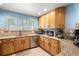 Well-lit kitchen featuring wooden cabinets, granite countertops, stainless steel appliances and modern design at 8105 E Bayaud Ave, Denver, CO 80230