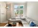 Bright living room with large windows and a comfortable white sectional sofa at 8105 E Bayaud Ave, Denver, CO 80230
