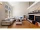Bright living room with vaulted ceilings, hardwood floors, stone fireplace, and comfortable seating area at 8105 E Bayaud Ave, Denver, CO 80230