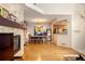 Bright open concept showcasing a stone fireplace, dining area, and a glimpse of the kitchen at 8105 E Bayaud Ave, Denver, CO 80230