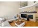 Bright living room with vaulted ceilings, stone fireplace, hardwood floors, and comfortable seating area at 8105 E Bayaud Ave, Denver, CO 80230