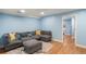 Living room with hardwood floors, gray sectional, and a patterned rug at 8105 E Bayaud Ave, Denver, CO 80230