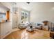 Well-lit living room with high ceilings, large windows, and a neutral color palette at 8105 E Bayaud Ave, Denver, CO 80230