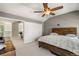 Bedroom with a wooden bed frame, vaulted ceiling, and a ceiling fan, plus access to the upstairs hallway at 8105 E Bayaud Ave, Denver, CO 80230
