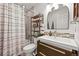 Well-lit bathroom with modern fixtures, featuring a shower with a curtain and a stylish vanity at 3835 Shefield Dr, Broomfield, CO 80020