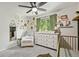 Bright Bedroom with charming decor, featuring a comfortable chair, white dresser, and decorative wall art at 3835 Shefield Dr, Broomfield, CO 80020