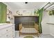 Adorable Bedroom featuring a gold metal crib, white dresser, black accent wall and closet at 3835 Shefield Dr, Broomfield, CO 80020