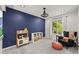 Bright bedroom with blue accent wall, gray carpet, white trim, and a window with natural light at 3835 Shefield Dr, Broomfield, CO 80020