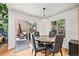 Cozy dining room with a modern light fixture, table and chairs, and sliding glass door to the deck at 3835 Shefield Dr, Broomfield, CO 80020