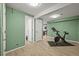 Inviting exercise room boasts neutral tones, laminate flooring, and Peloton bike, promoting a healthy lifestyle at 3835 Shefield Dr, Broomfield, CO 80020