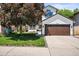 Charming home showcasing a large front yard, mature trees, and a well-maintained exterior with a two-car garage at 3835 Shefield Dr, Broomfield, CO 80020