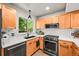 Well-lit kitchen with white subway tile, ample cabinets, modern black appliances, and a stylish black sink at 3835 Shefield Dr, Broomfield, CO 80020