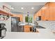 Bright kitchen featuring white quartz countertops, shaker cabinets, stainless steel appliances, and modern fixtures at 3835 Shefield Dr, Broomfield, CO 80020
