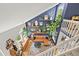 This is a view from above looking into the living room with a leather couch and decorative shelves at 3835 Shefield Dr, Broomfield, CO 80020