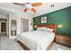 Inviting main bedroom featuring a decorative green wall, stylish lighting, and a comfortable queen-size bed at 3835 Shefield Dr, Broomfield, CO 80020