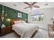Inviting main bedroom featuring a decorative green wall, stylish lighting, and large window at 3835 Shefield Dr, Broomfield, CO 80020