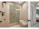 Walk-in shower featuring a tiled accent wall, built-in bench, and modern fixtures at 3835 Shefield Dr, Broomfield, CO 80020