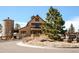 Exterior view of Grand Hall, surrounded by landscaping, near a paved street at 21418 E Stroll Ave, Parker, CO 80138