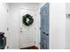 Hallway with white walls, hardwood floors, and stylish pantry door at 21418 E Stroll Ave, Parker, CO 80138