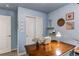 Well-lit home office with wooden desk, closet and blue painted walls at 21418 E Stroll Ave, Parker, CO 80138