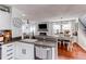 An eat-in kitchen boasts stainless appliances, white cabinets, and wood floors at 21418 E Stroll Ave, Parker, CO 80138