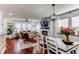 Open-concept living and dining area with hardwood floors, modern light fixtures, and stylish decor at 21418 E Stroll Ave, Parker, CO 80138