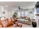 Bright and open living room boasts stylish furniture, hardwood floors, and plentiful natural light at 21418 E Stroll Ave, Parker, CO 80138