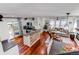Open-concept living room featuring wood floors, modern furnishings, and sliding glass doors to outdoor patio at 21418 E Stroll Ave, Parker, CO 80138