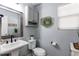 Cozy powder room with pedestal sink, modern fixtures, and decorative wall accents at 21418 E Stroll Ave, Parker, CO 80138