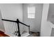 Staircase with carpeted steps and white railings at 21418 E Stroll Ave, Parker, CO 80138