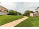 Scenic community walking path winds through lush green lawns and mature trees at 21418 E Stroll Ave, Parker, CO 80138