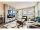 Cozy living room showcasing a modern fireplace, elegant decor, and abundant natural light streaming through the windows at 11216 Uptown Ave, Broomfield, CO 80021