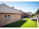 A covered outdoor seating area with a built-in grill sits on manicured lawn at 7931 W Paine Ave, Lakewood, CO 80235