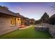 Backyard with manicured lawn, stone water feature, and outdoor patio, creating an inviting outdoor living space at 7931 W Paine Ave, Lakewood, CO 80235